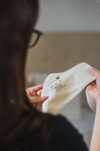 Person holding a a cream House of Dayne Bamboo Liner